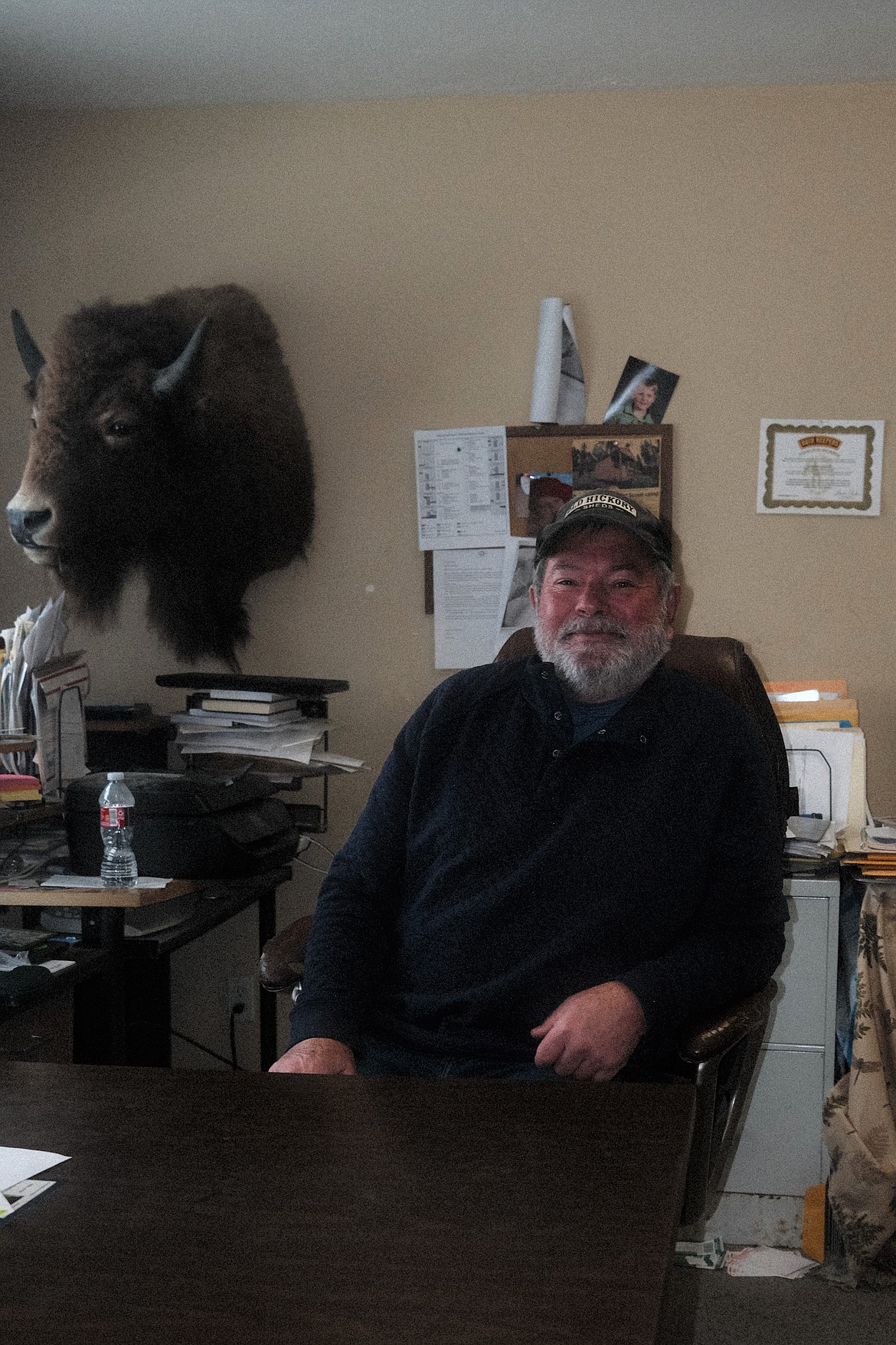 Gordy Lister sits at his desk in his office at Gordy's Old Hickory Sheds, in Evergreen Montana. (Adrian Knowler/Daily Inter Lake)