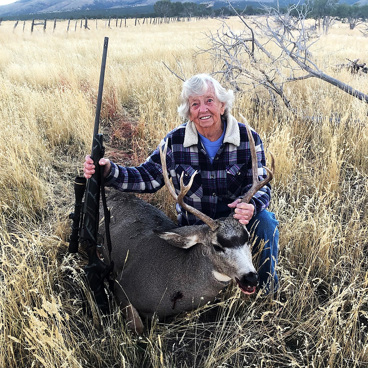 Mildred Bryant is pictured with her buck after the 90-year-old celebrated her 80th anniversary of hunting by harvesting the mule deer.