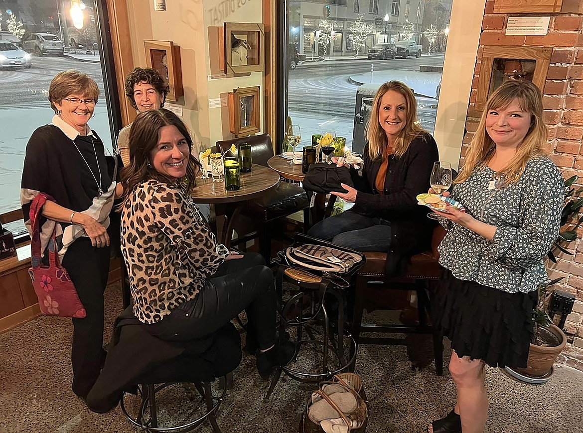 Shoppers catch up at a past Purse Party event. At the event, which benefits North Idaho CASA, gently-loved handbags are donated and then sold for charity.