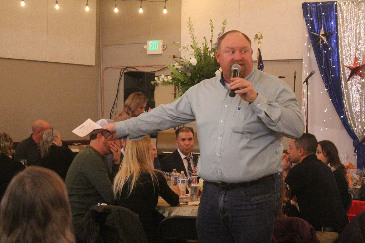 Auctioneer Chuck Yarbro manages the bids during the Quincy Valley Chamber of Commerce and Quincy Rotary Club banquet.