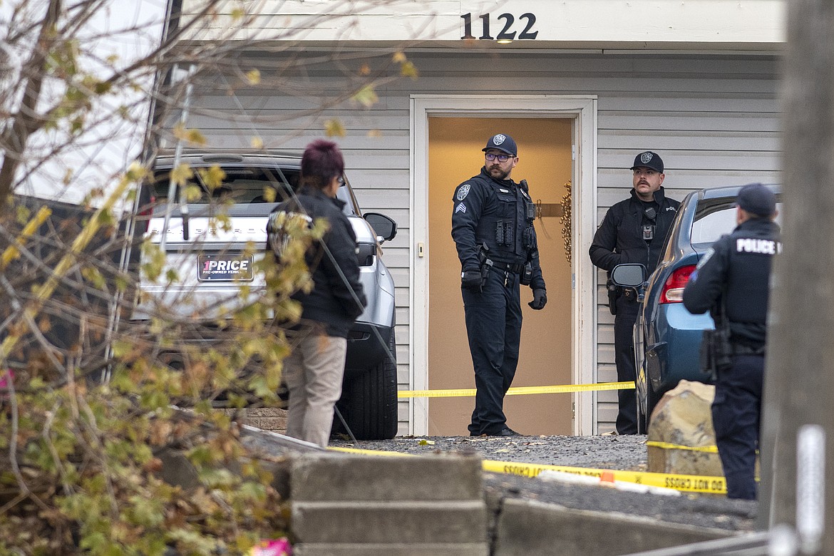 Officers investigate a homicide at an apartment complex south of the University of Idaho campus on Sunday, Nov. 13, 2022. Four people were found dead on King Road near the campus, according to a city of Moscow news release issued Sunday afternoon. (Zach Wilkinson/The Moscow-Pullman Daily News via AP)