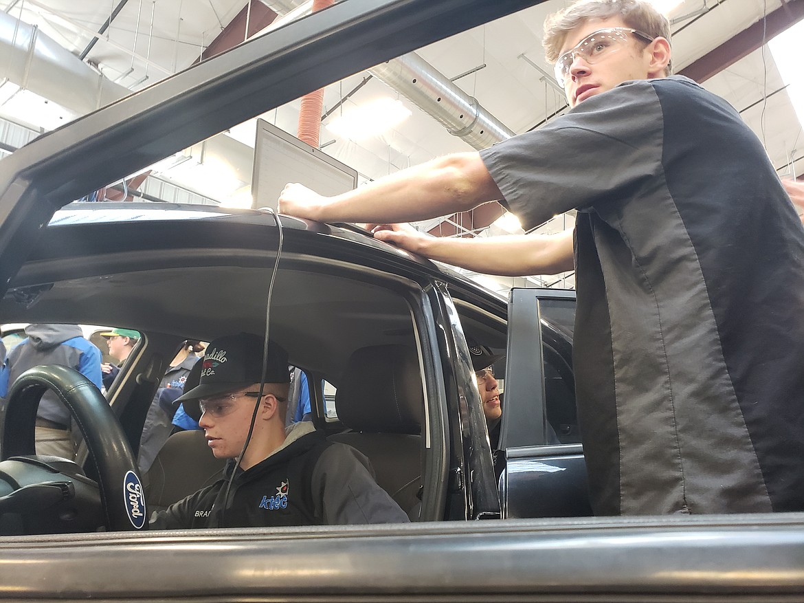 KTEC students hook up one of two donated vehicles to a computer to diagnose any mechanical issues on the car. The Ford cars were donated as training materials for the KTEC automotive department, to strengthen student's skills in more modern vehicle computers.