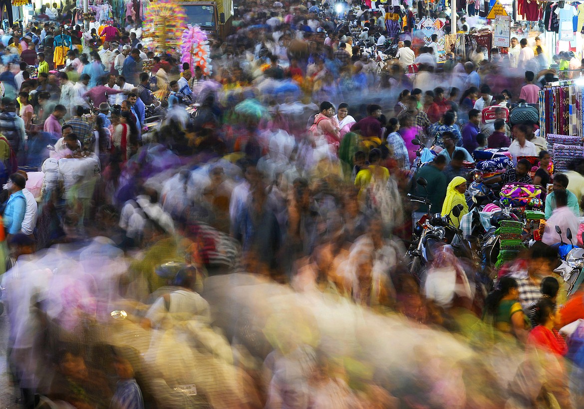 People move through a market in Mumbai, India, Saturday, Nov. 12, 2022. The world's population is projected to hit an estimated 8 billion people on Tuesday, Nov. 15, according to a United Nations projection. (AP Photo/Rajanish Kakade)