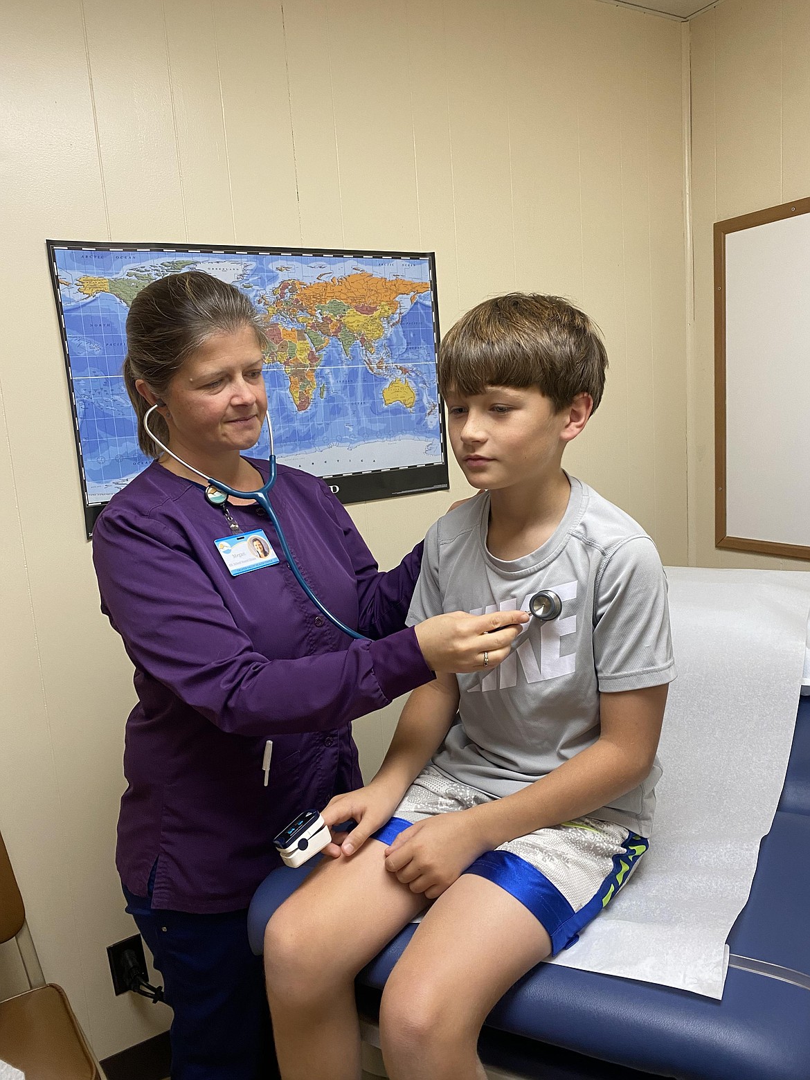 Evergreen Cares Clinic Nurse Megan Nerdit examines Carter Hardman. (Courtesy photo)