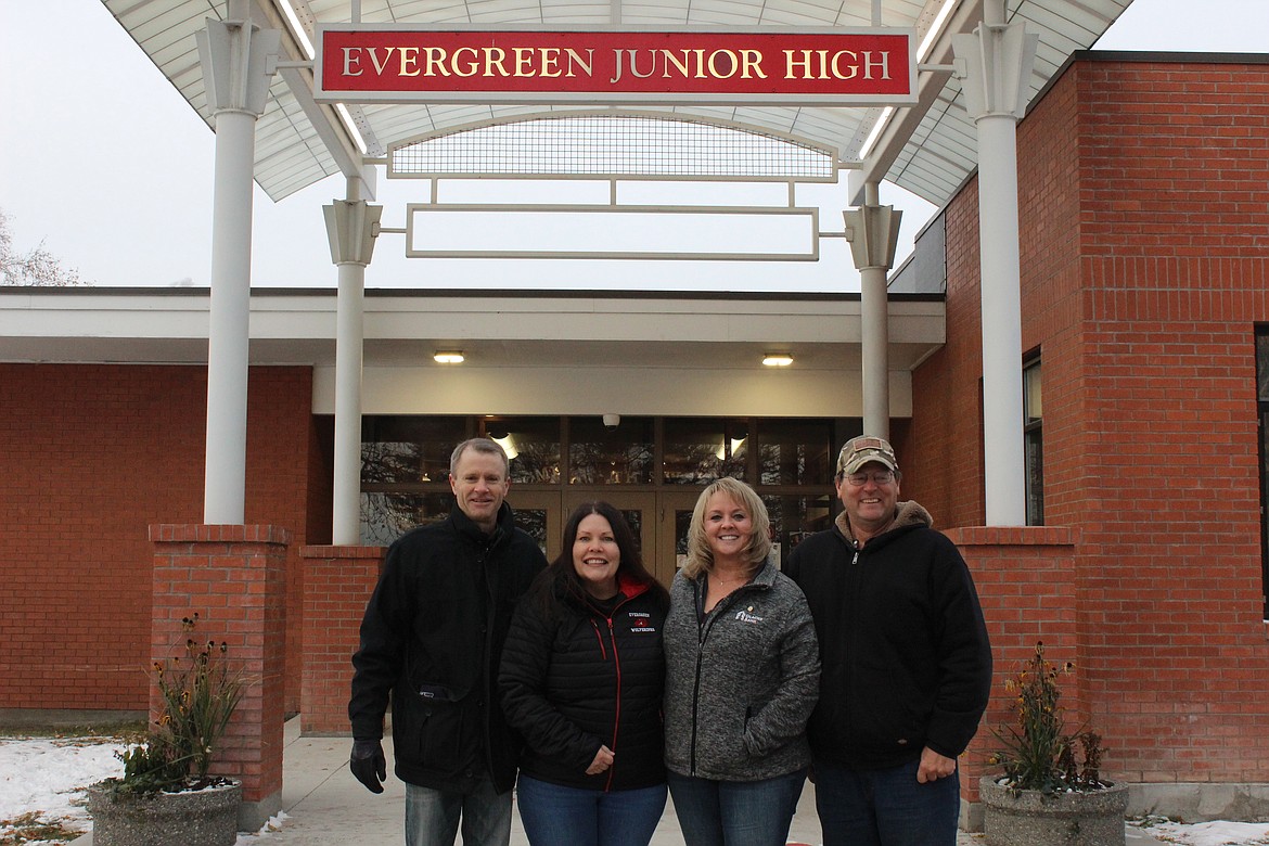 Evergreen Rotarians Charles Eble, Laurie Barron, Roxanne Swartzenberger and Charles Lapp stand in front of Evergreen Junior High on Nov. 11, 2022. (Taylor Inman/Daily Inter Lake)