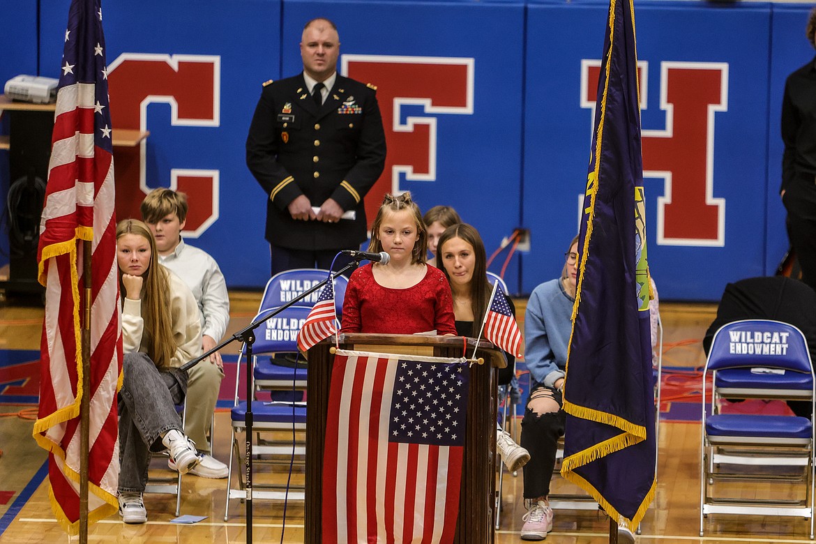 Sarin Bates reads her Veteran's Day poem at the assembly on Thursday. (JP Edge photo)