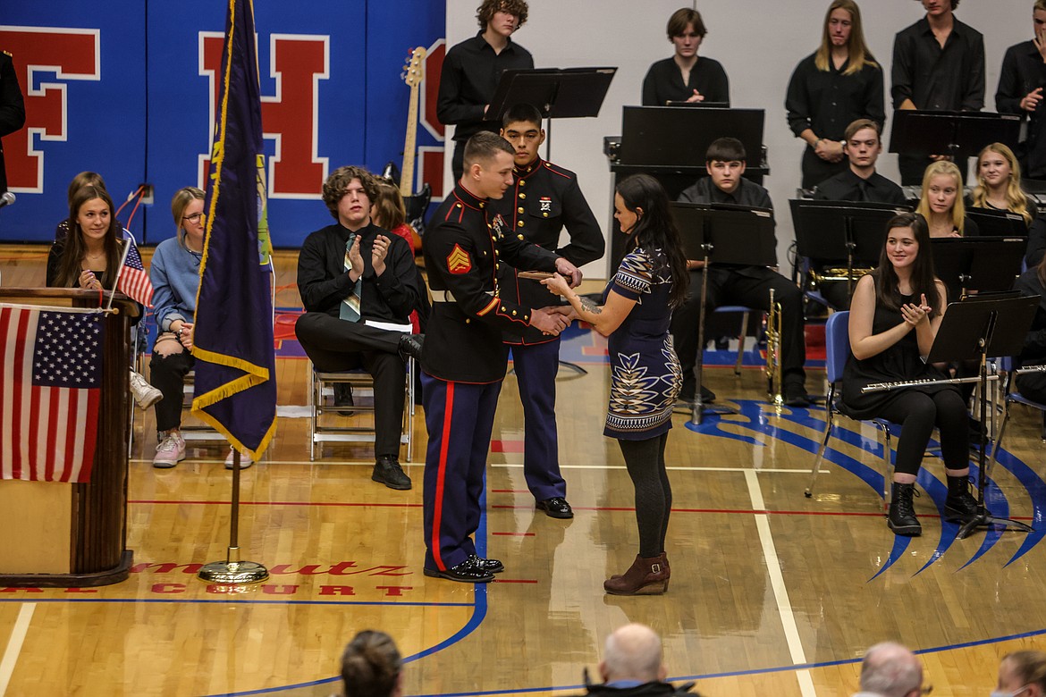 Marine Sgt. Waite gives Hannah Rily the Karel Hagen Award at the Veteran's Day assembly last Thursday. (JP Edge photo)