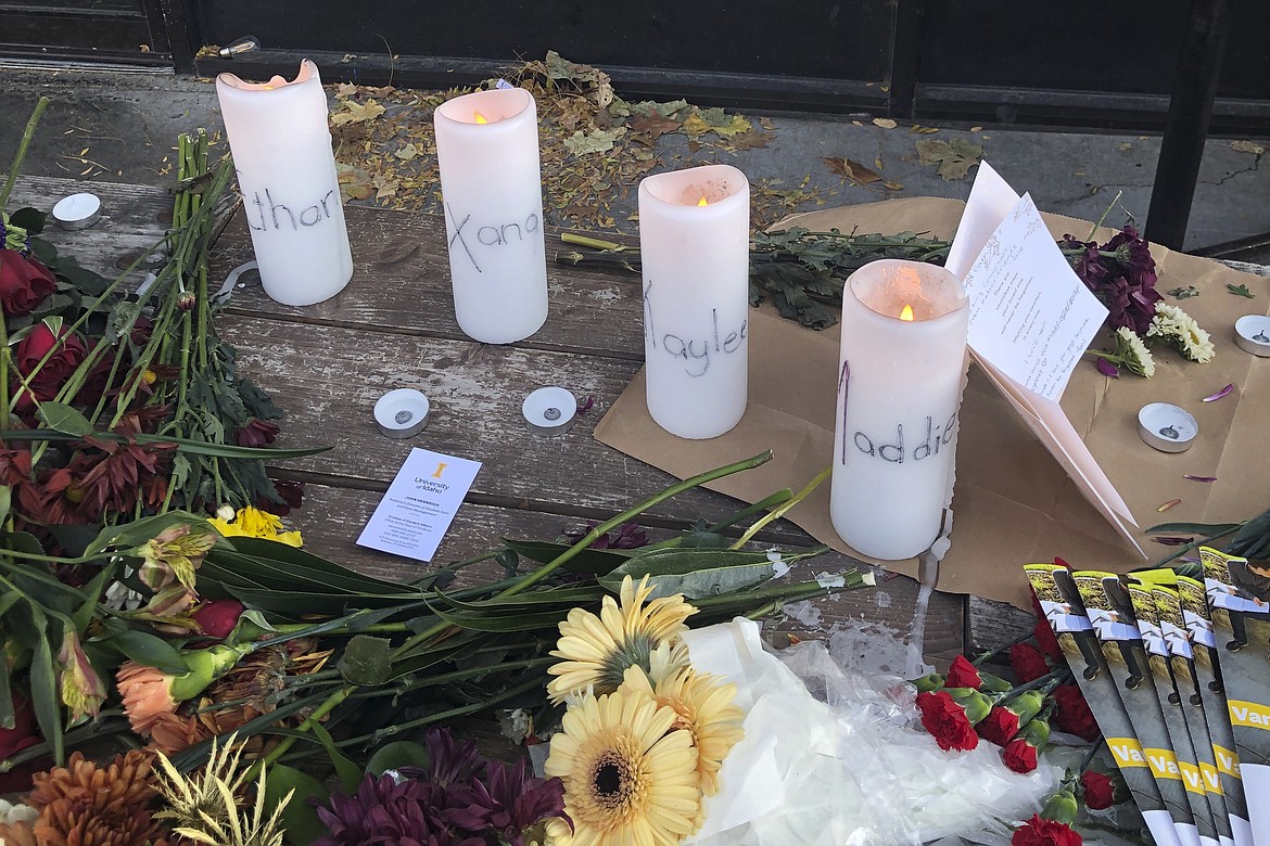 Candles and flowers are left at a make-shift memorial honoring four slain University of Idaho students outside the Mad Greek restaurant in downtown Moscow, Idaho, on Tuesday, Nov. 15, 2022. Police discovered the bodies of the four students at home near campus on Sunday, Nov. 13, 2022, and said the killer or killers used a knife or bladed weapon in the targeted attack. Two of the victims, 21-year-old Madison Mogen and 20-year-old Xana Kernodle, were servers at Mad Greek.