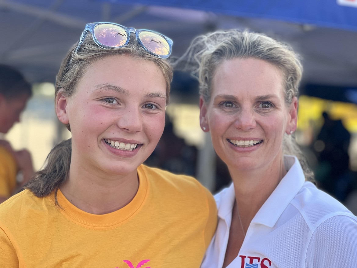 Kathryn DuVall (left) and Hollie DuVall (right) smile at the Zones Championship Meet in Clovis, California. Kathryn DuVall swam in the meet, while Hollie DuVall officiated the meet.