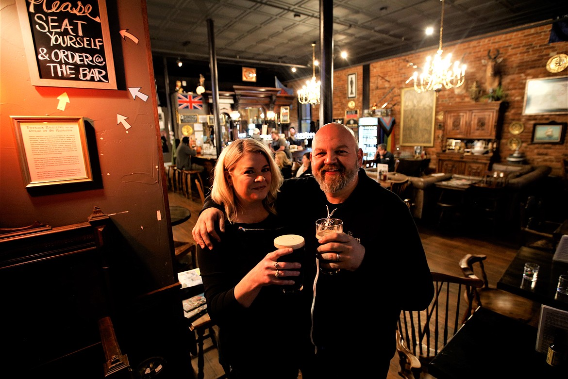 Crown and Thistle owners Ben and Jennifer Drake hold glasses of Guinness.