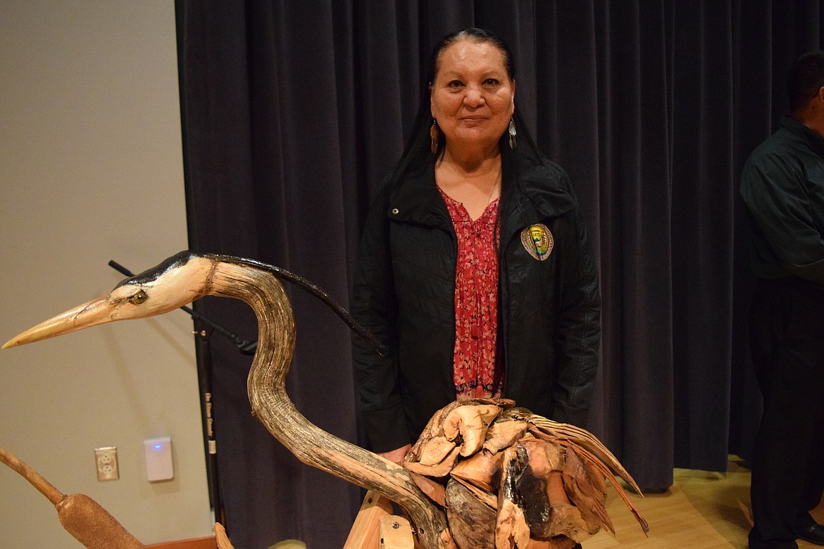 Confederated Tribes of the Colville Reservation Business Council member Karen Condon stands beind a driftwood sculpture of a heron made by former Moses Lake resident Mike Salazar for the land acknowledgment ceremony Tuesday.