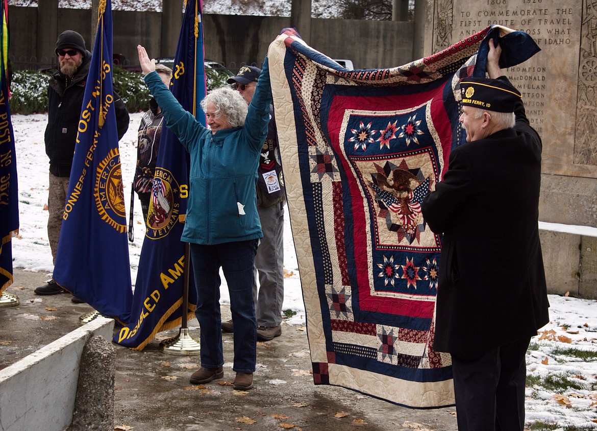 Margaret Pyette presents on of the patriotic quilts she made for two local veterans.