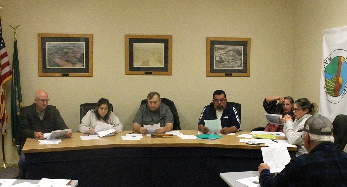 The Royal City City Council (from left) Michael Christensen, Perla Garcia, Mayor Kent Anderson, Hector Rodriguez, Mackenzee Anderson and Tiffany Workinger look over a draft of the city’s 2023 budget at Tuesday’s meeting.