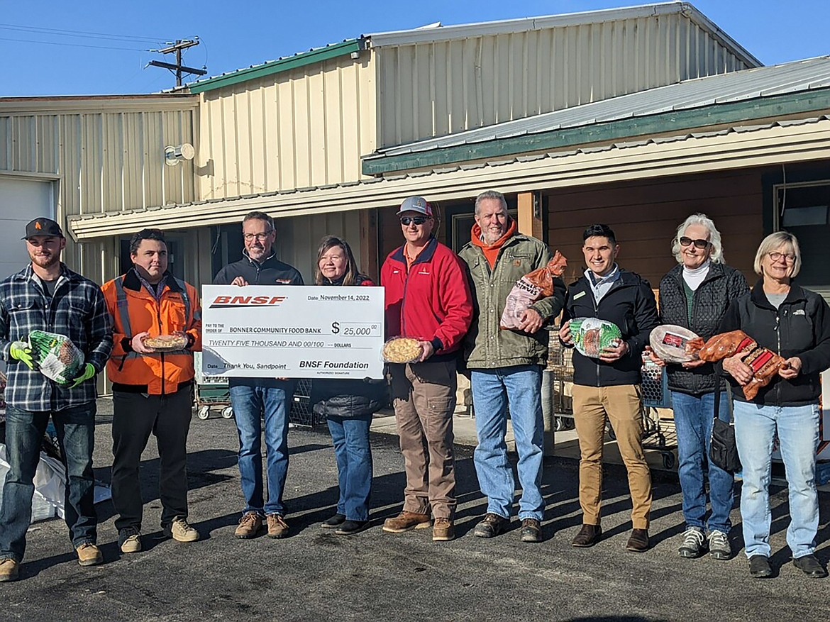 BNSF Railway, Ames Construction and Bonner County Food Bank officials gather for a photo after both donated to the food bank to help others in the community. Pictured, from left, are Sawyer Junker, Ames; Ryan Kopera, BNSF; Matt Jones, BNSF; Debbie Love, Bonner Community Food Bank; Mike Pamperin, Ames; Max Rexroad, Hanson; Jake Garringer, office of Idaho Gov. Brad Little; Roz Holland, Bonner Community Food Bank; and Judy Thompson, Bonner Community Food Bank.