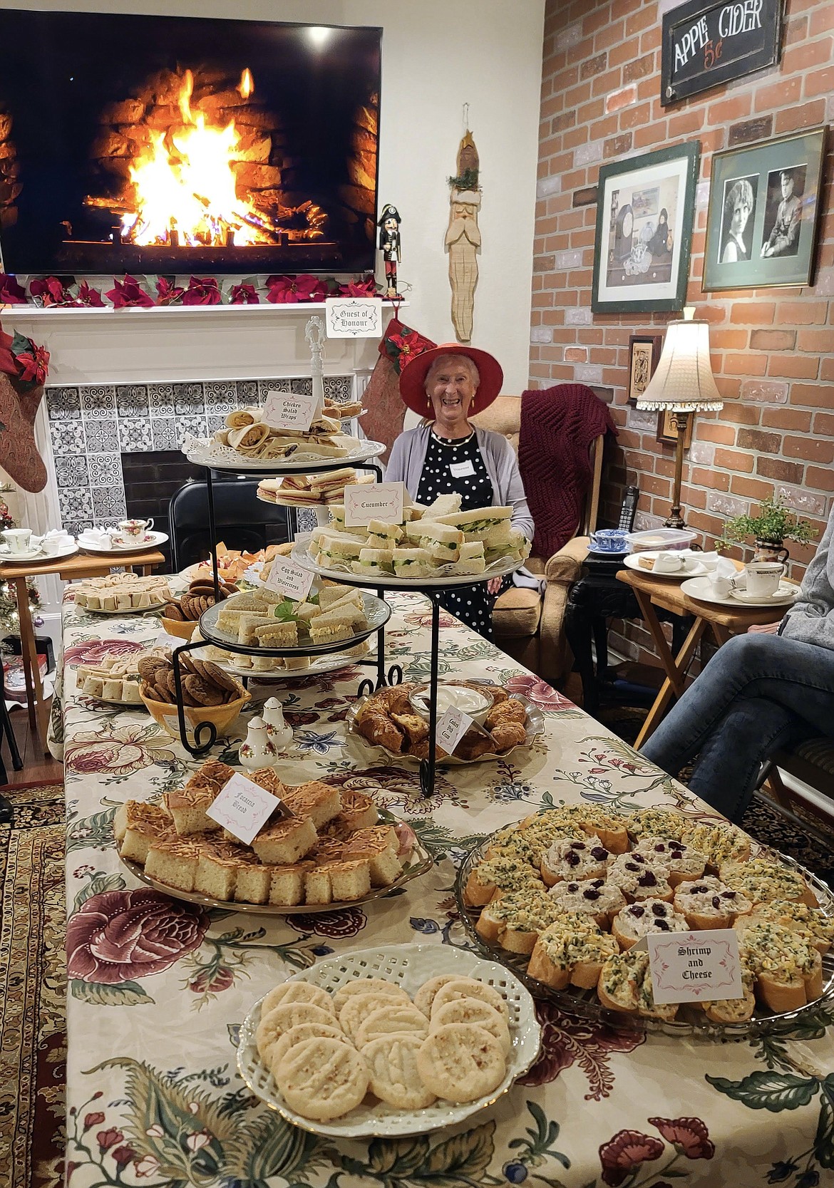 Vivienne Montague seated at the table of English tea delicacies prepared from her own recipes by the women of Easthaven Church on Oct. 29. (photo provided)