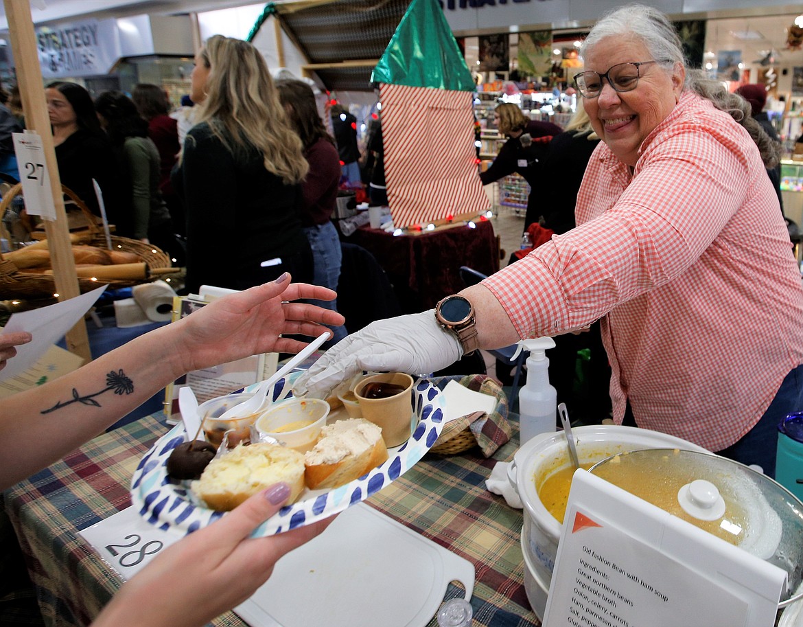 Tina Clifton serves old-fashioned bean with ham soup at the First Pentecostal Church of Post Falls booth at the Souport the End of Homelessness on Thursday at the Silver Lake Mall.