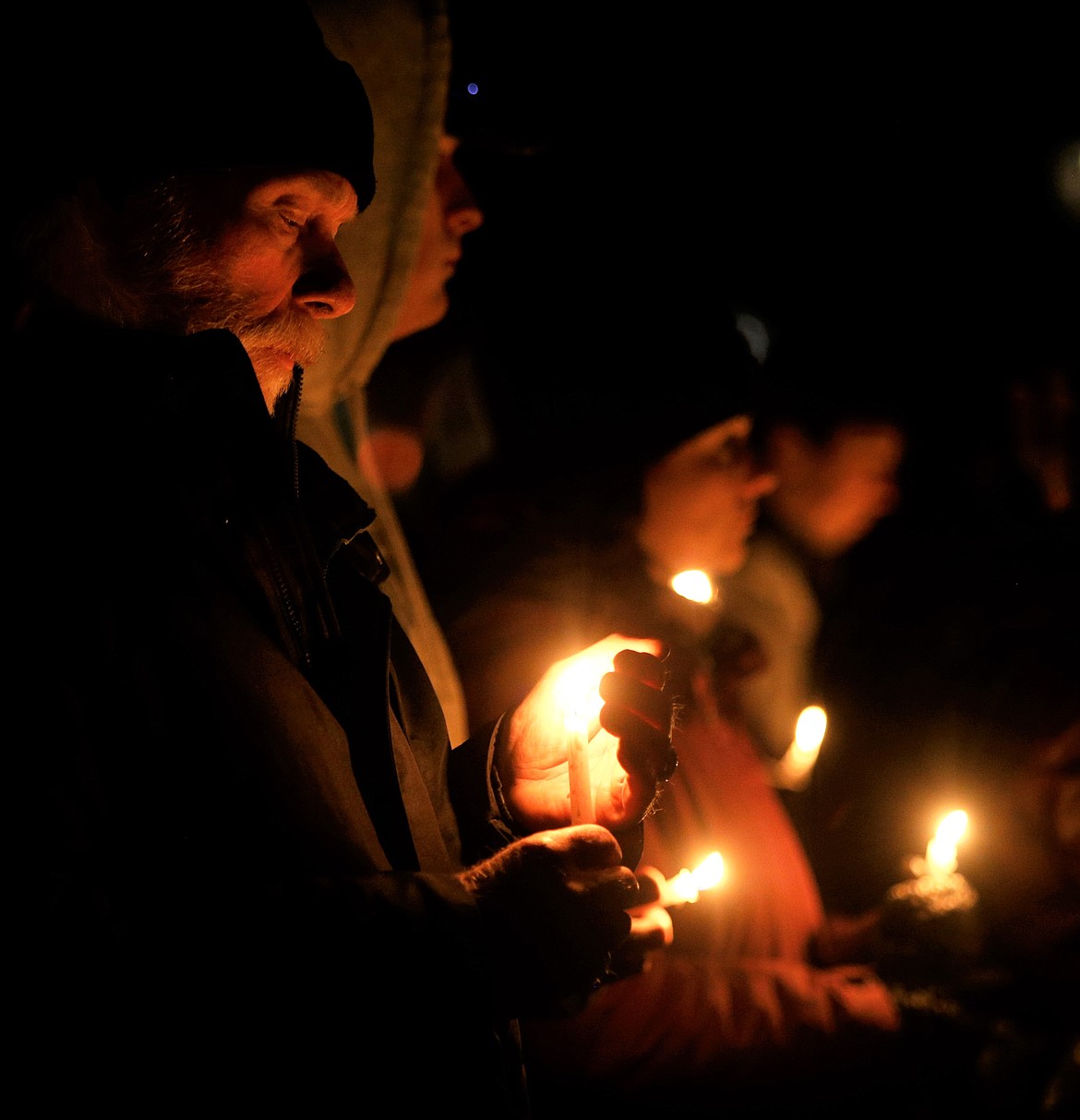 A man holds a candle during a vigil at Independence Point on Wednesday to honor the four University of Idaho students who died in Moscow this week.