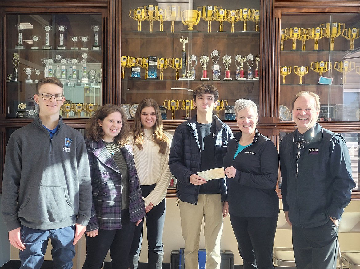 National Honor Society students from the North Idaho STEM Charter Academy conducted a weeklong coin drive, raising $3,650 for charity. Students chose Safe Passages as the community recipient and Director Sally Winn received the donation Nov. 18 on behalf of Safe Passages. Pictured rom left are NHS officers Colin Clang, Karalie Potter, Miranda Ripley, Roman Guthrie-McNerney, Winn, and STEM Executive Director Scott Thomson.