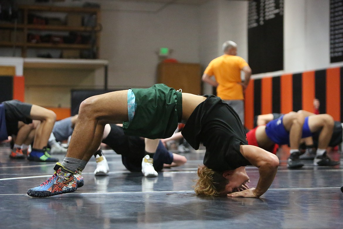 Ephrata senior Nelson Barragan stretches his body out during practice before moving into one-on-one wrestling sessions.