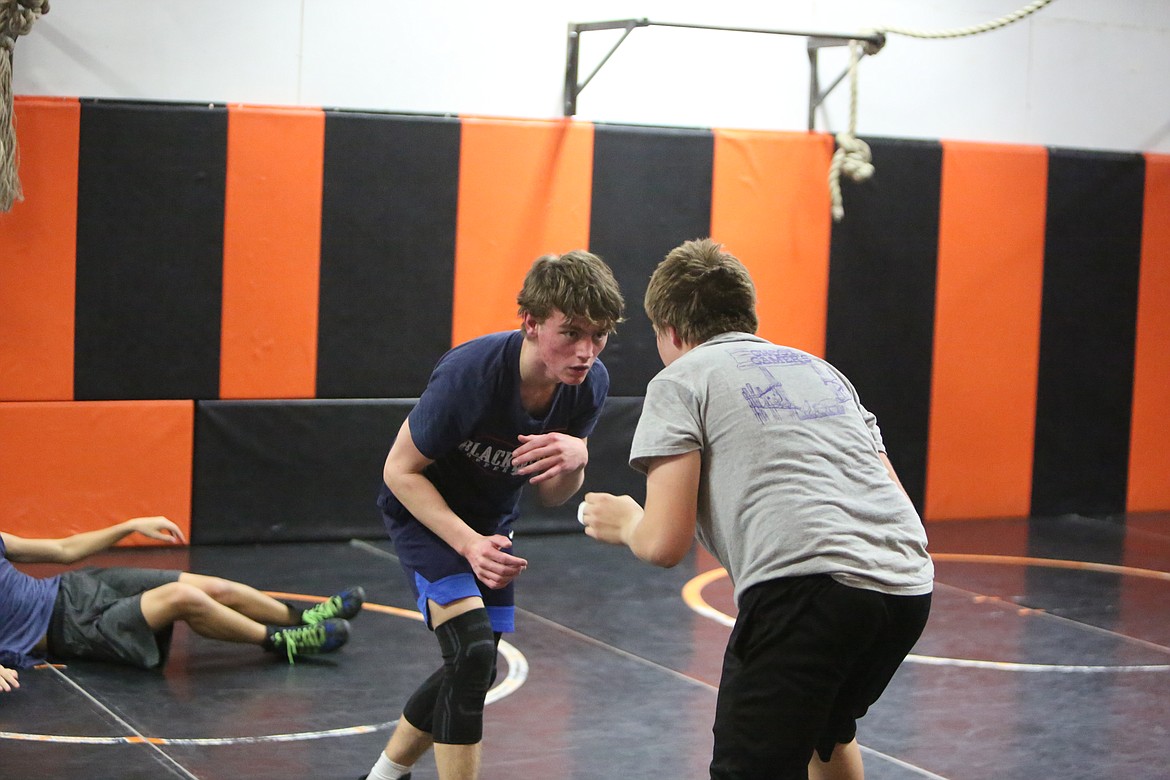 Tiger wrestlers break up into pairs during practice to work on newly-learned moves.