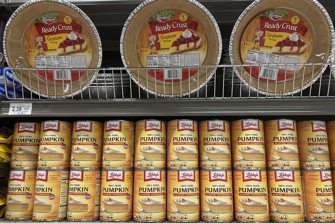 File - Canned pumpkin and graham cracker shell crusts are displayed at a Publix Supermarket, Tuesday, Nov. 16, 2021 in North Miami, Fla. Americans are bracing for a costly Thanksgiving this year, with double-digit percent increases in the price of turkey, potatoes, stuffing, canned pumpkin and other staples. (AP Photo/Marta Lavandier, File)