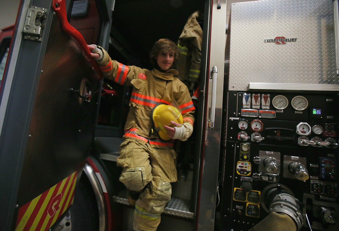 Coeur d'Alene Fire Cadet Matt Willhite steps down from a fire engine Wednesday at Station 3 in Coeur d'Alene. Applications for spring semester fire cadet training will be accepted until 4 p.m. Friday.