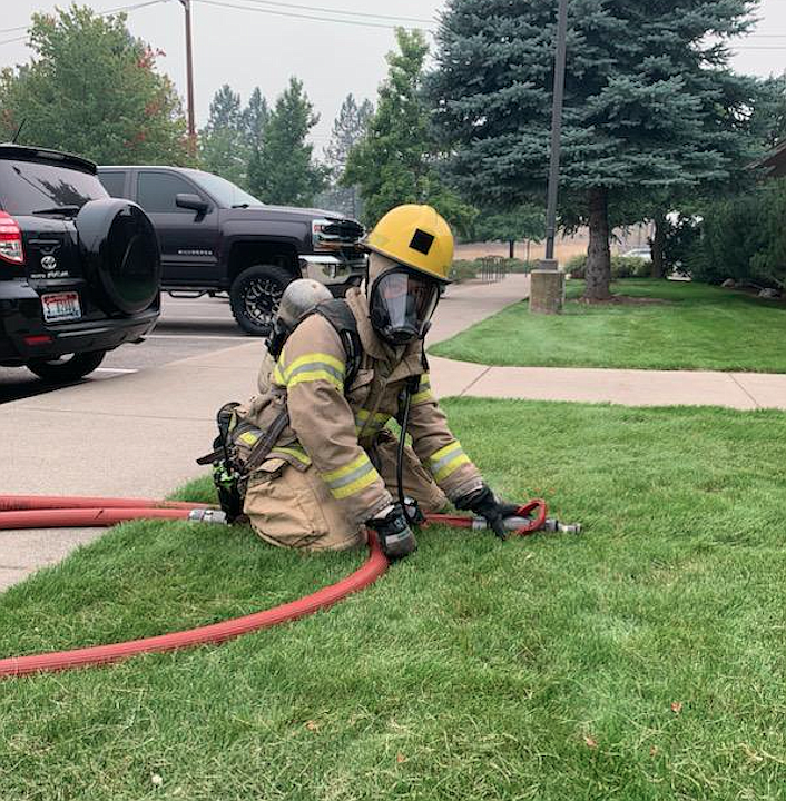 Jane Schlosser, Coeur d'Alene High senior, pulls a hose line from a fire engine during fire cadet training with the Coeur d'Alene Fire Department. Applications for spring fire cadet training are due by 4 p.m. Friday.