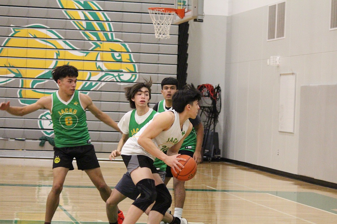 Quincy basketball players work on both defense and offense.