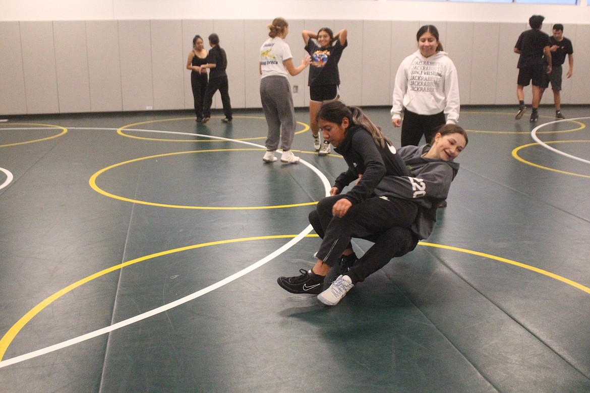 Quincy girls wrestlers work on their technique during practice.