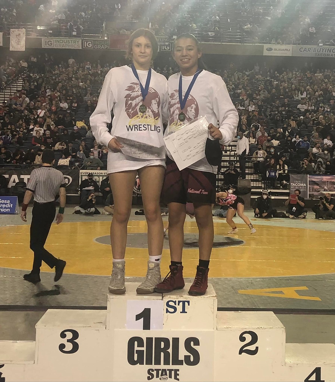 Moses Lake seniors Bianca Johnson (left) and Ashley Naranjo (right) stand atop the podium at last year’s state tournament. Both Johnson and Naranjo placed first in their weight classes.
