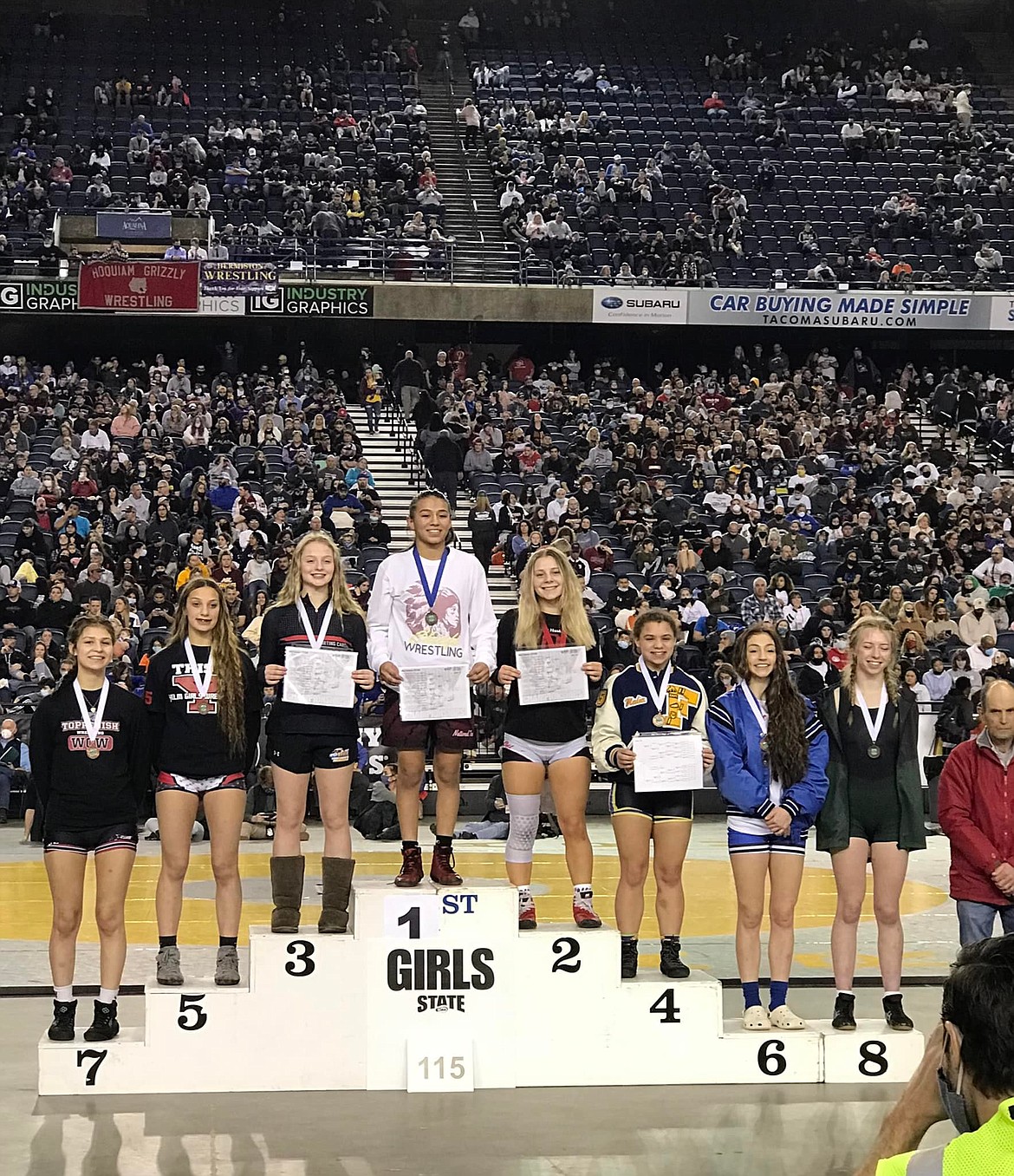Moses Lake senior Ashley Naranjo poses with other wrestlers at the WIAA Mat Classic after finishing first in the 115 weight class.