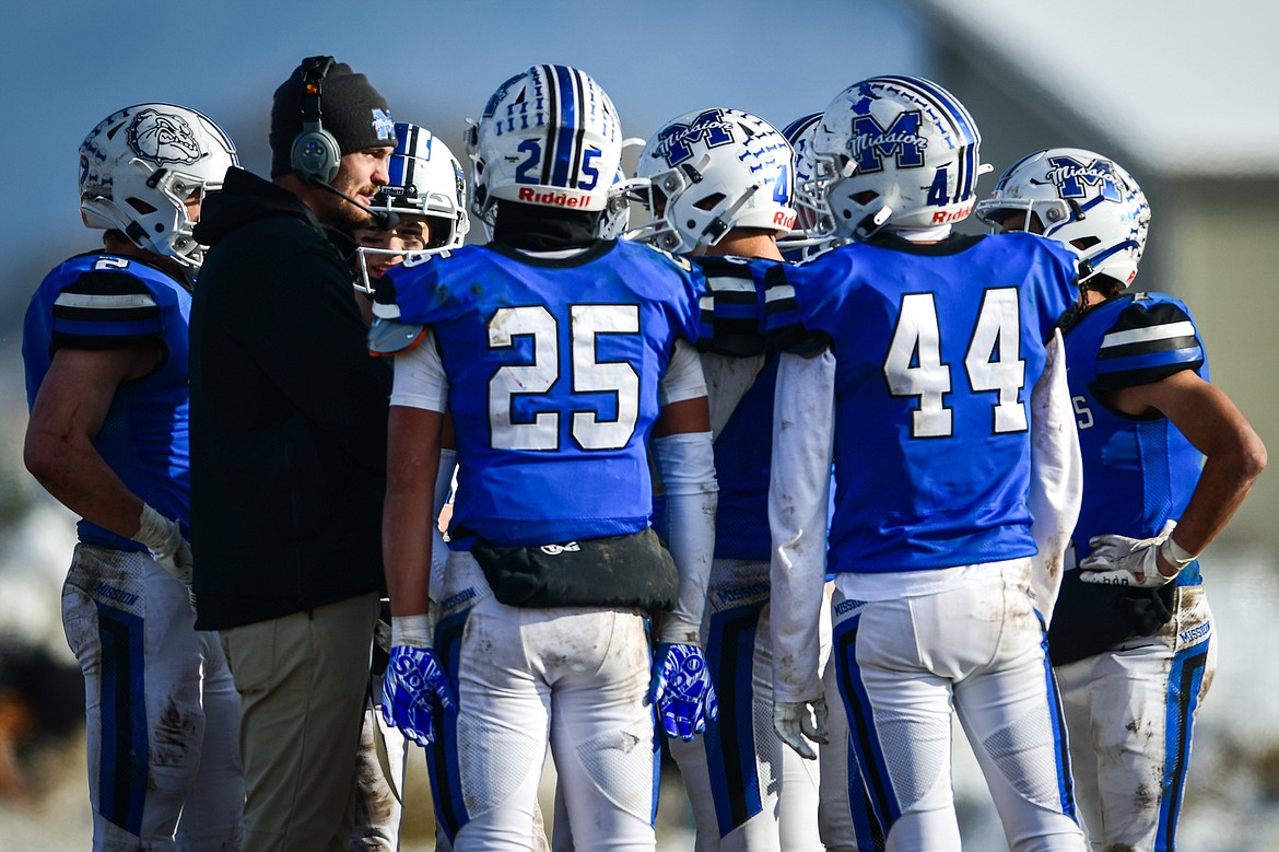 Misson head coach Carson Oakland talks to the Bulldogs during a timeout as they take on Belt during the 8-man championship at St. Ignatius High School on Saturday, Nov. 19. (Casey Kreider/Daily Inter Lake)