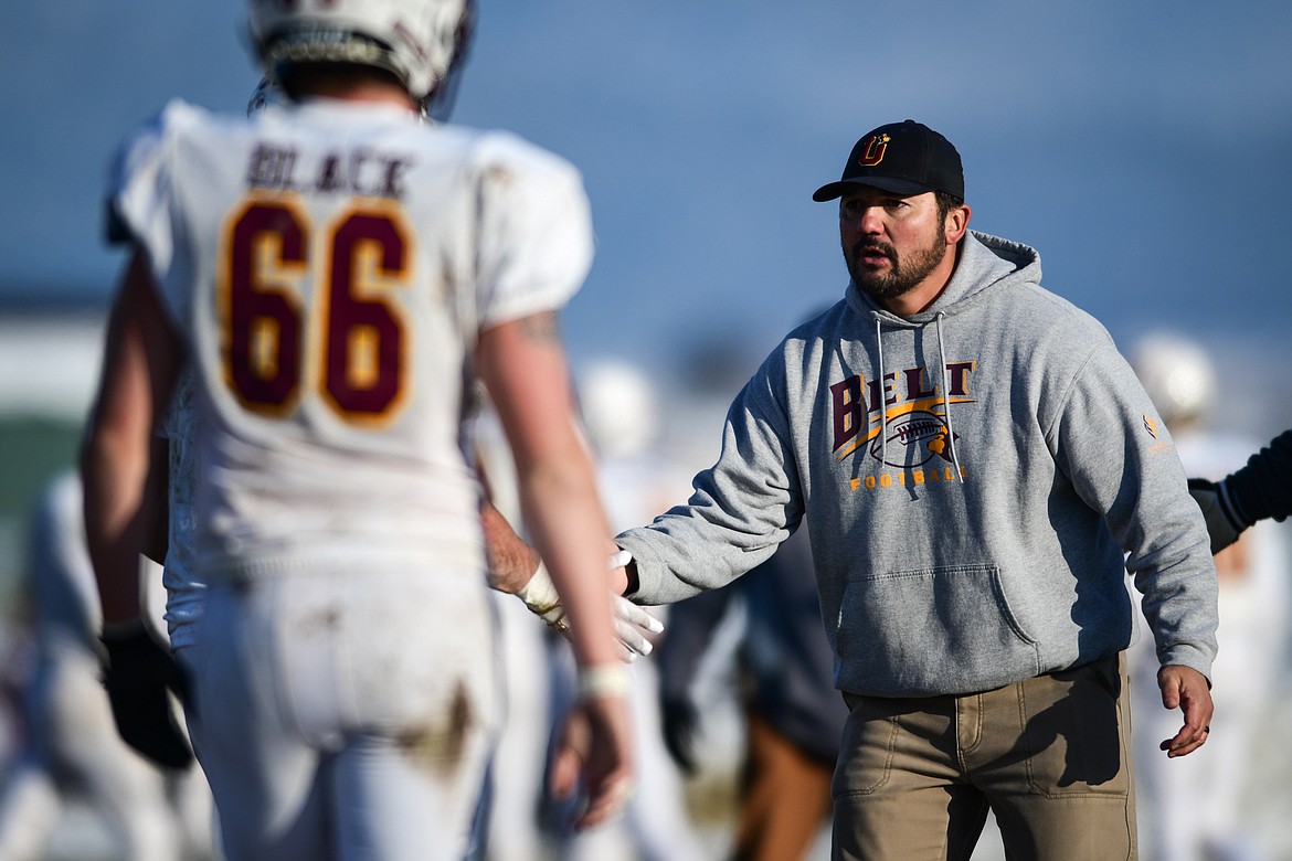 Belt head coach Matt Triplett congratulates his players as they come off the field after a touchdown and two-point conversion in the third quarter against Mission during the 8-man championship at St. Ignatius High School on Saturday, Nov. 19. (Casey Kreider/Daily Inter Lake)