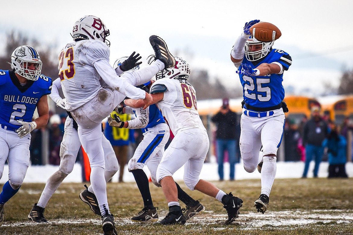 Mission defender Kenny Ness (25) blocks a punt by Belt's Bridger Vogl (23) that would be picked up and returned for a touchdown by Canyon Sargent (2) in the first quarter during the 8-man championship at St. Ignatius High School on Saturday, Nov. 19. (Casey Kreider/Daily Inter Lake)