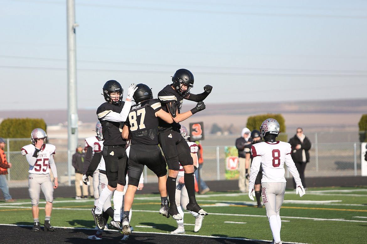 Royal’s Caden Allred (left), Bennett Brown (right) and Edgar De La Rosa (right) celebrate in the end zone after Brown’s touchdown catch.