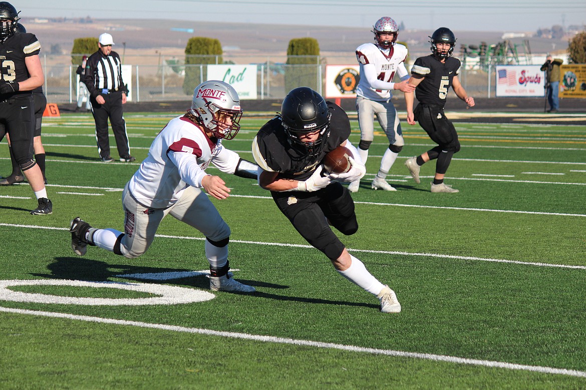 Royal receiver Lance Allred runs past a Montesano would-be tackler in the first half.