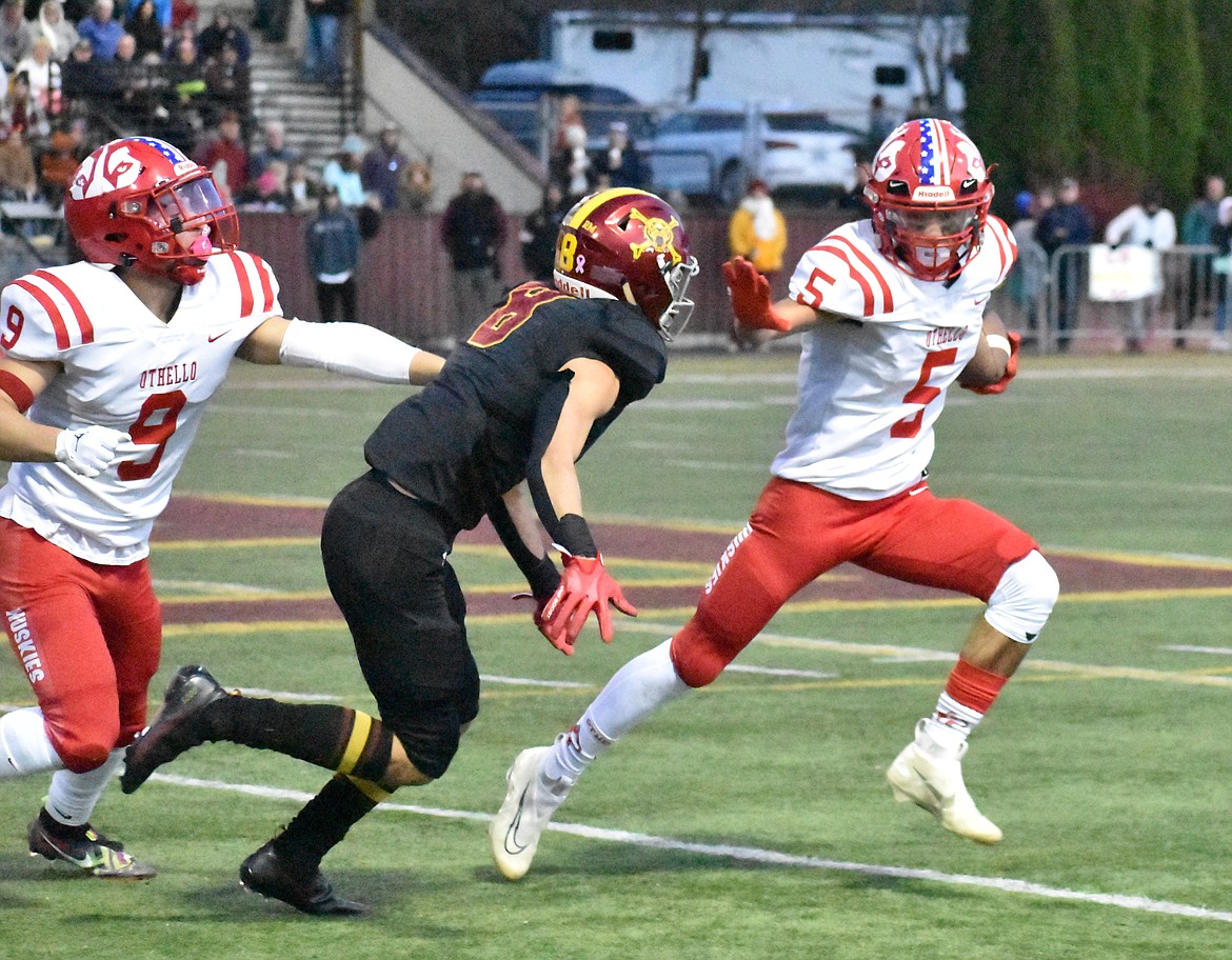 Othello receiver Adriel Deleon (5) stiff-arms an Enumclaw defender in the Huskies’ 20-17 loss to the Hornets on Saturday.