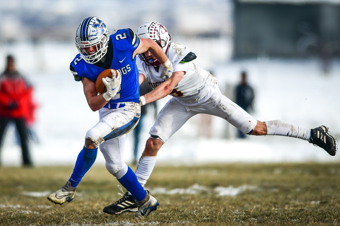 Mission running back Canyon Sargent (2) tries to fend off Belt defender Ethan Triplett (9) on a first-quarter run during the 8-man championship at St. Ignatius High School on Saturday, Nov. 19. (Casey Kreider/Daily Inter Lake)