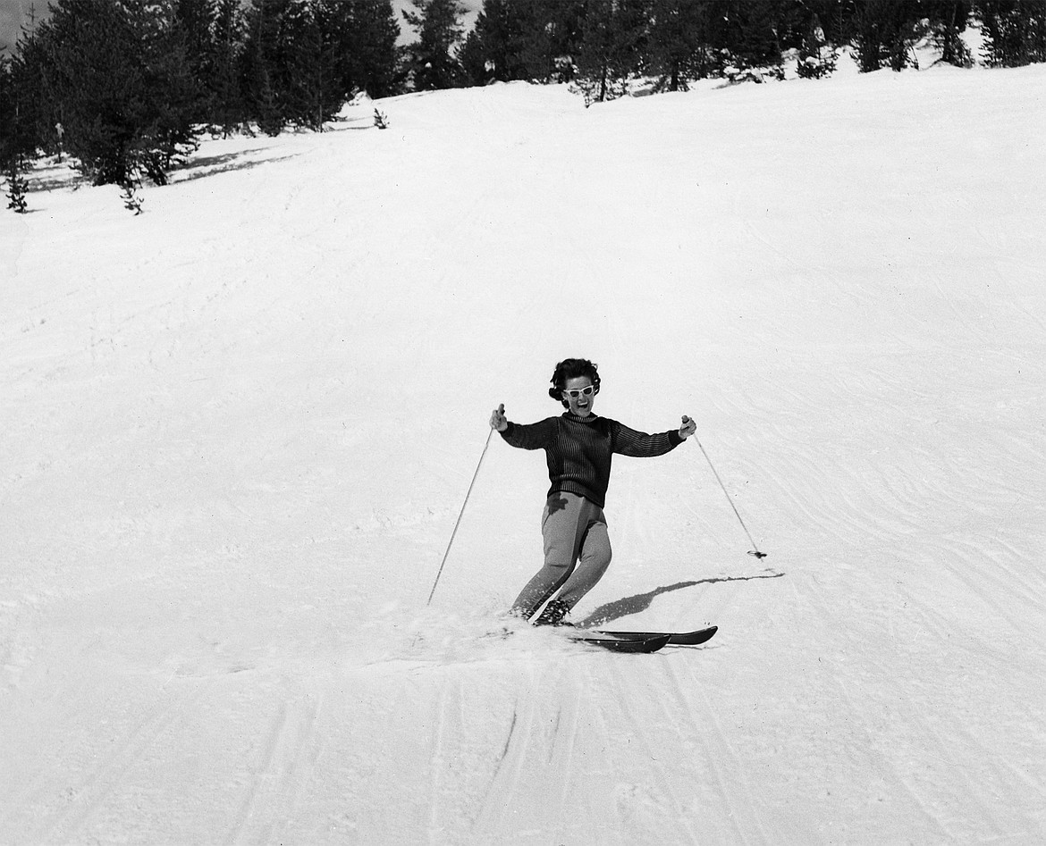 A skier wearing sunglasses comes down the slopes at Big Mountain in this undated photo. (Photo by Marion Lacy, courtesy of Whitefish Mountain Resort)