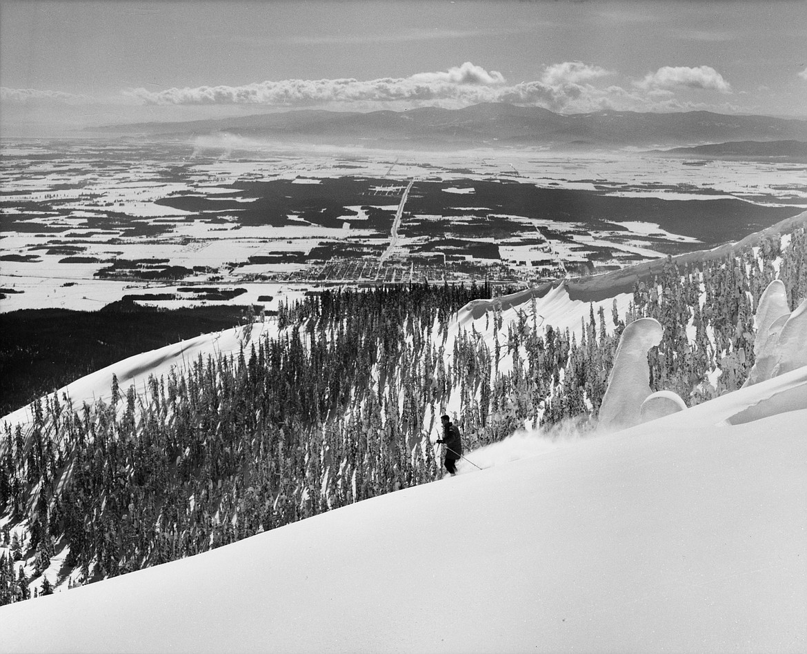 A skier takes in the views of the Flathead Valley from Big Mountain. (Photo by Marion Lacy, courtesy of Whitefish Mountain Resort)