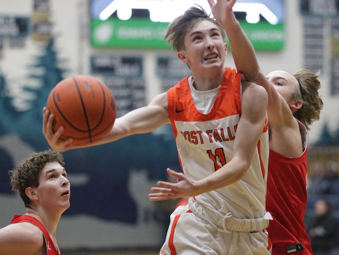 MARK NELKE/Press
Cobe Cameron (11) of Post Falls goes up for a shot against Sandpoint on Tuesday in a high school boys basketball jamboree at Lake City High.