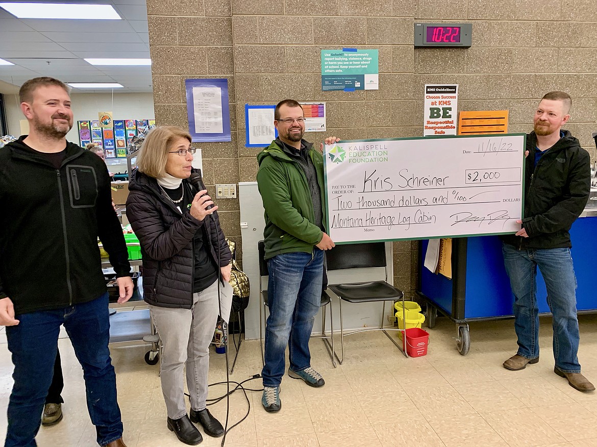 Kalispell Middle School social studies teacher Kris Schreiner receives a $2,000 Kalispell Education Foundation (KEF) Great Opportunities grant presented by KEF board member Dr. Lynn Dykstra and Morrison-Maierle representatives and grant project sponsors Tom Coburn and Ryan Jones. (Photo provided by Dorothy Drury)