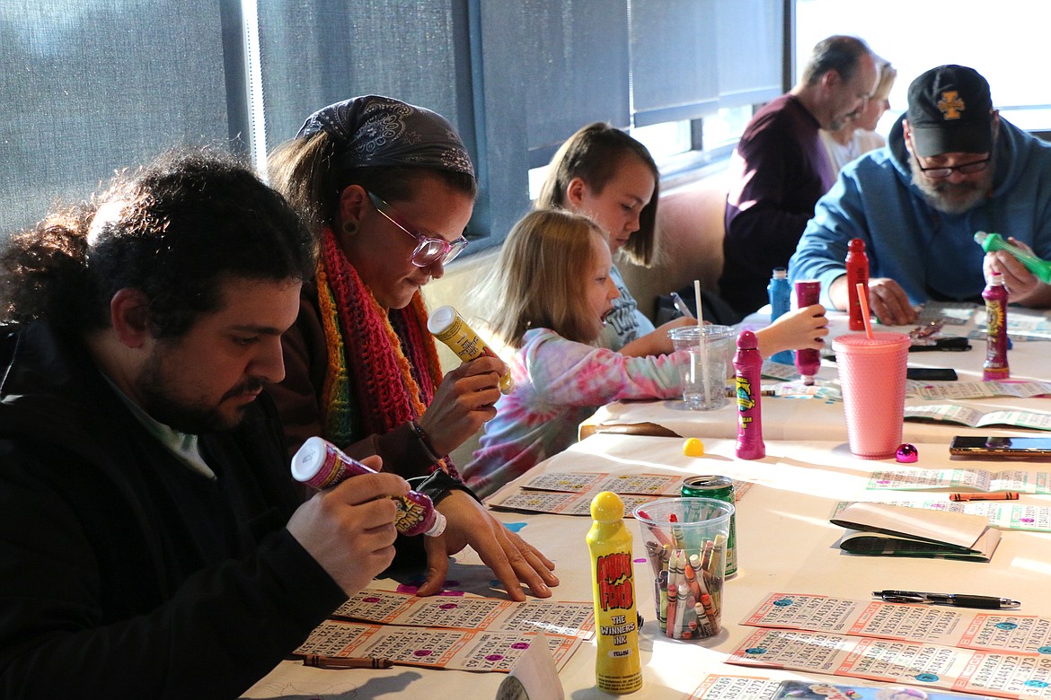 A family concentrates as they play Turkey Bingo on Saturday.