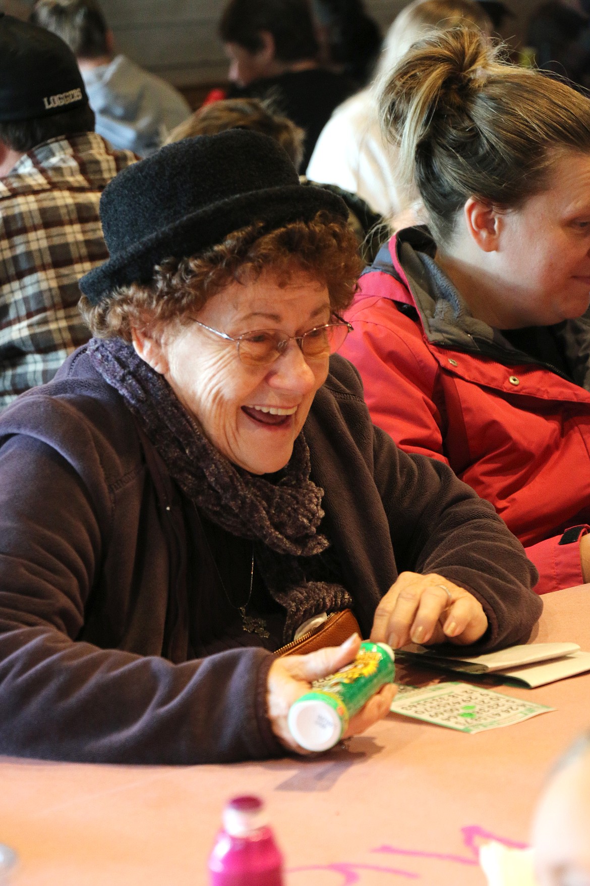 A bingo player laughs while talking with friends and family at Saturday's Turkey Bingo game. The annual Sandpoint Lions' fundraiser is held to raise money for the club's Toys for Tots Christmas campaign.