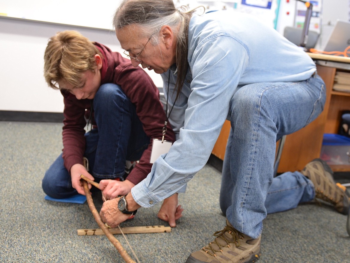 Forget the matches -- Tim Ryan coaches a student at Polson Middle School Tuesday on the art of fire-making with primitive tools. (Kristi Niemeyer/Lake County Leader)