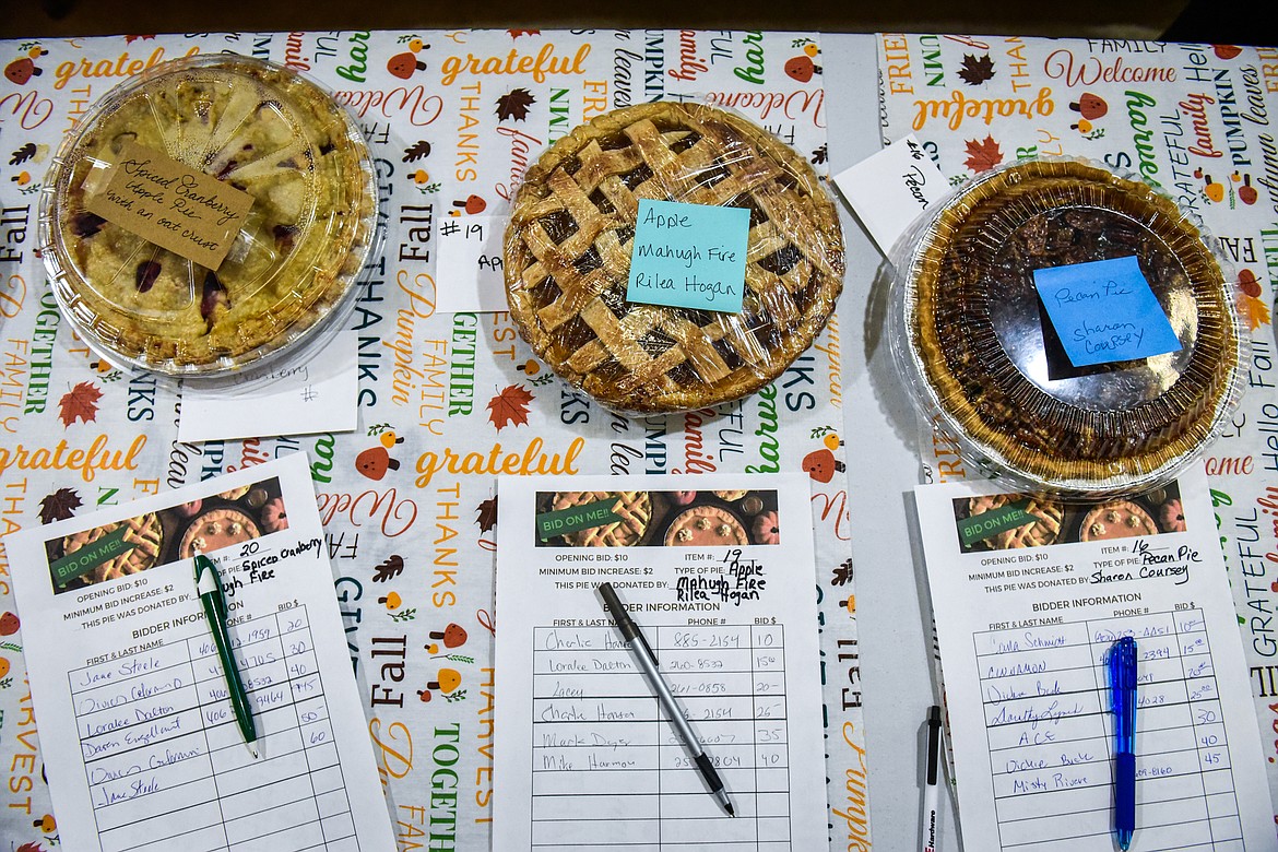 Pies and their bid sheets during the silent auction at Light Up Evergreen & Pie Auction at Glacier Ace Hardware on Tuesday, Nov. 22. (Casey Kreider/Daily Inter Lake)
