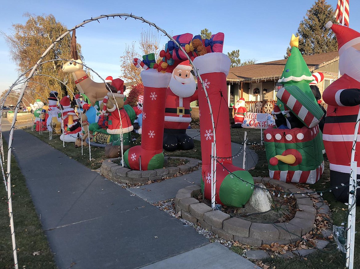 Santas, reindeer, snowmen and other Christmas icons fill the Coulter yard. Across the street, their neighbor James Hash prefers Star Wars characters with a dash of Peanuts. It’s all what you love, he said.