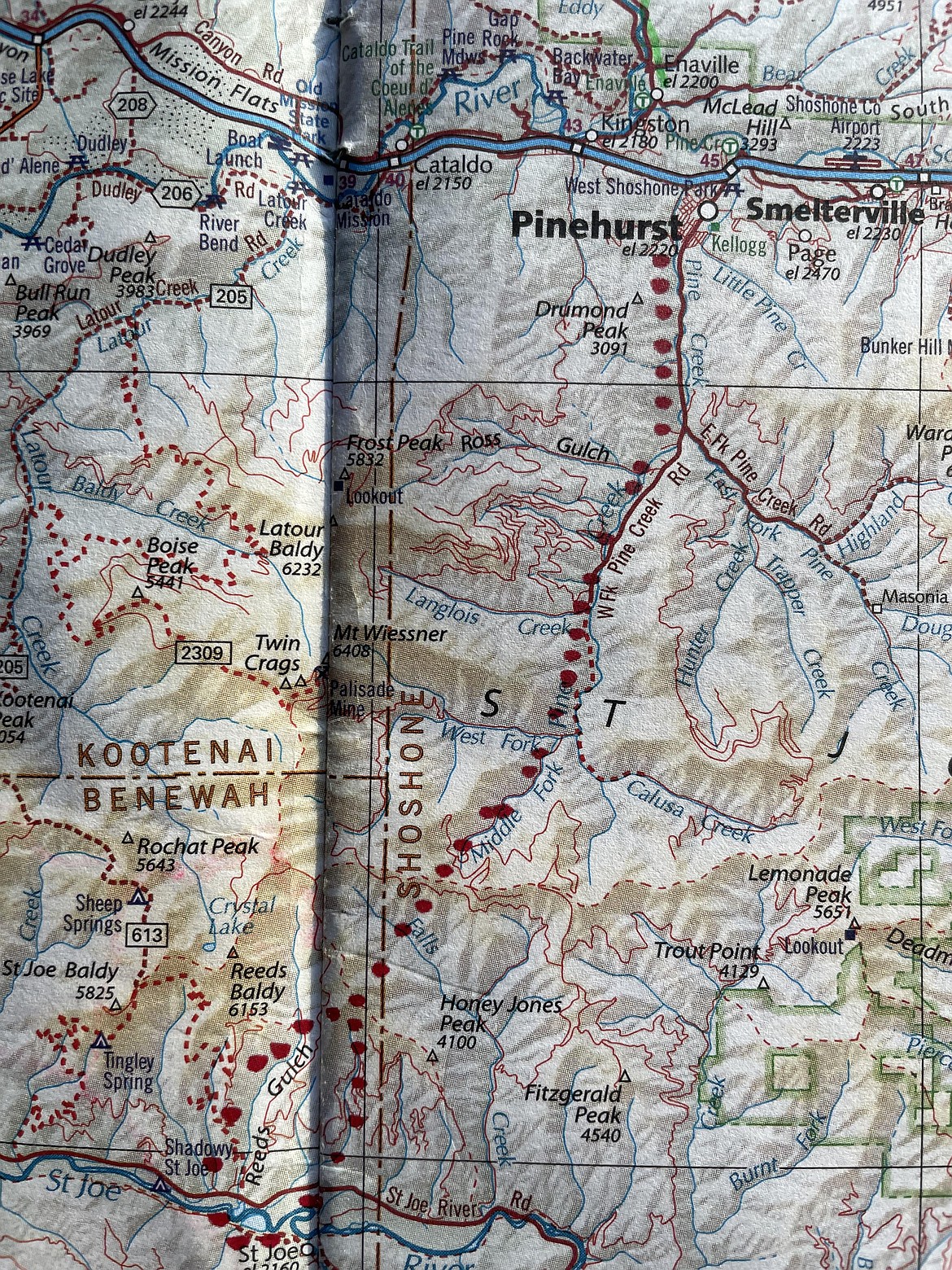 The red dots on this map show where a proposed road over the Coeur d'Alene/St. Joe Divide was likely intended to run. This is based on information from the book "Pioneer Days on the Shadowy St. Joe" by Orland A. Scott.