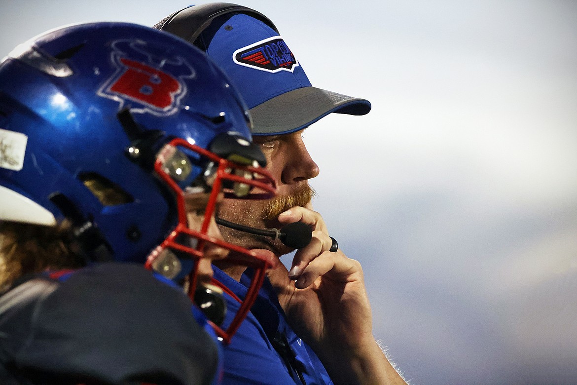 Bigfork head football coach Jim Benn confers with quarterback Tristen Herd during a game this season. Benn has been helping guide his players both on and off the field for nearly 30 years. (Jeremy Weber/Daily Inter Lake)