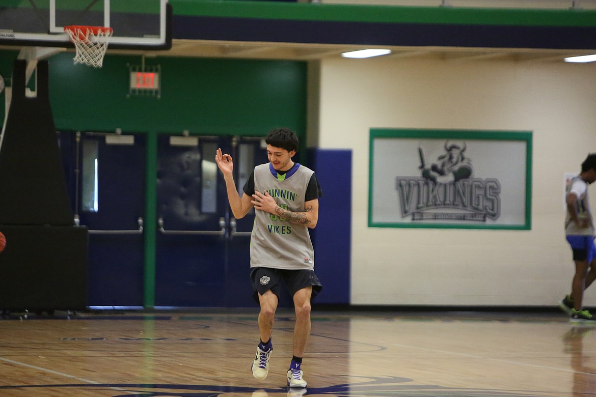 Sophomore Emiliano McMakin celebrates after making a three-point shot in practice.